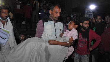 A man carries a child out from the Kamla Nehru Children’s Hospital after a fire in the newborn care unit of the hospital killed four infants, in Bhopal, India, on Nov. 8, 2021. (AP)