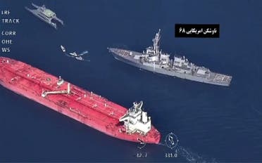 This video grab of a footage broadcast by the Iranian state TV on November 3, 2021, reportedly shows a US warship (top R) a Vietnam-flagged oil tanker (bottom) and Iranian Revolutionary Guards navy vessels, in the Gulf of Oman. (AFP)