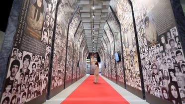 A Mujahedin-e Khalq member visits the exhibition which presents the story of the People's Mojahedin Organization of Iran (MEK) inside their camp in Manza, on July 10, 2021. / AFP / Gent SHKULLAKU