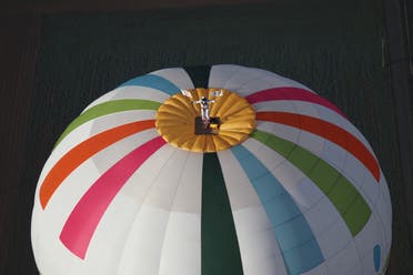 French balloonist Remi Ouvrard attempts to set a world record by standing on the top of a hot air balloon for the Telethon at an altitude of over 3637 meters on November 10, 2021 in Chatellerault, western France. The altitude should be the same of the phone number of the Telethon campaign 36-37. (AFP)