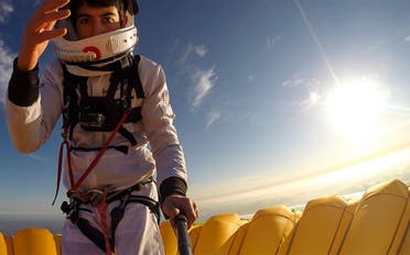 This selfie picture taken on November 10, 2021, shows French balloonist Remi Ouvrard attempting to set a world record by standing on the top of a hot air balloon for the Telethon at an altitude of over 3637 meters, in Chatellerault, western France. (AFP)