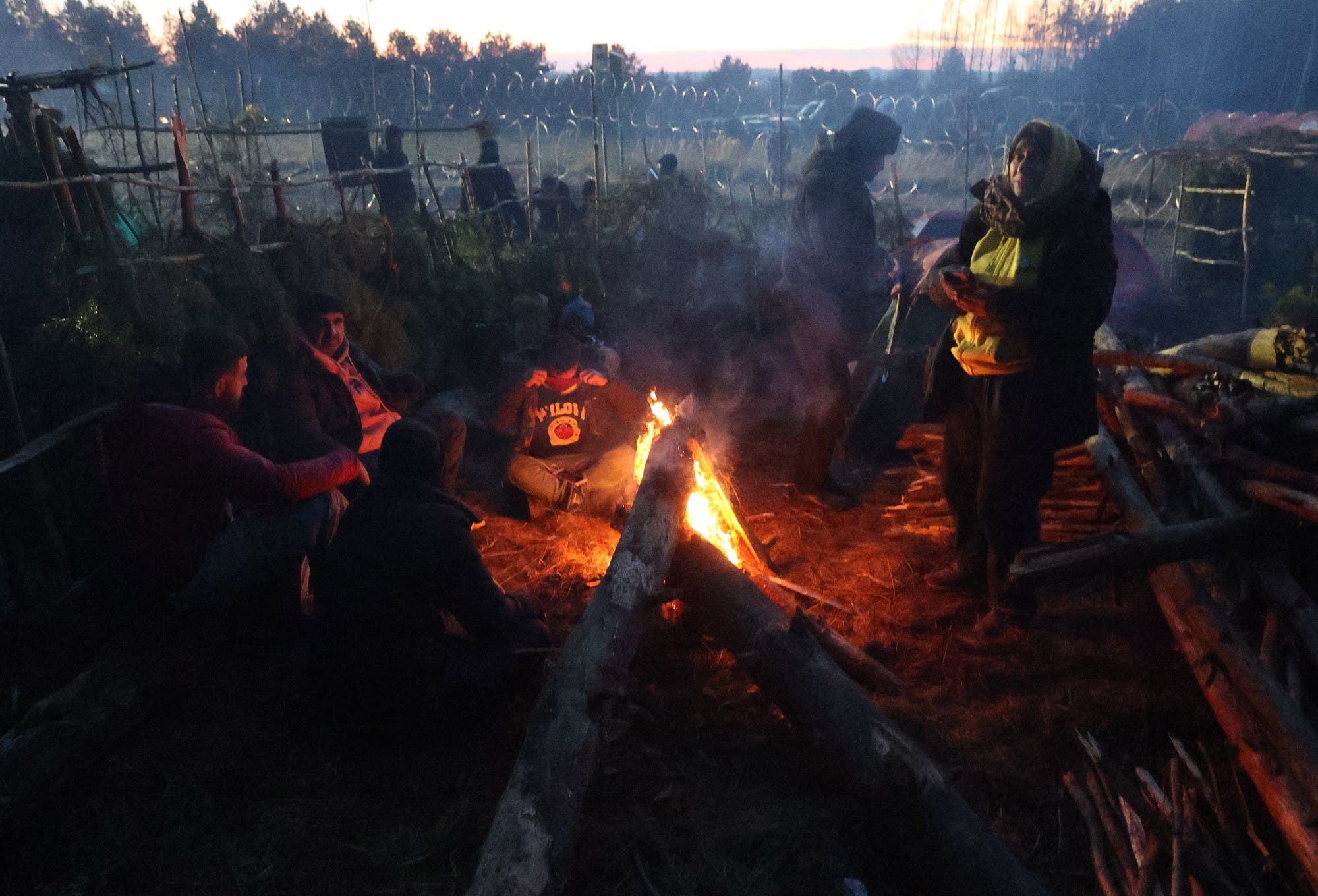 مهاجرون في مخيم على الحدود البيلاروسية البولندية يوم 10 نوفمبر (فرانس برس)