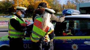 German police officers detain a migrant, reportedly coming from Iraq through Belarus and Poland, during a patrol near the German-Polish border, in Frankfurt (Oder), Germany, October 28, 2021. (Reuters/Michele Tantussi)