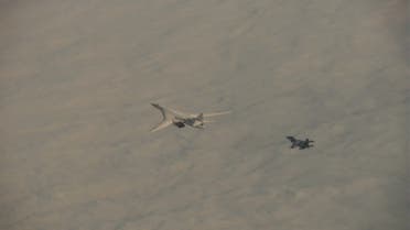 A Tu-160 strategic bomber of the Russian Aerospace Forces and a Su-30SM combat aircraft of the Belarusian Air Forces perform a flight in the airspace of the Republic of Belarus on November 11, 2021. (Russian Defense Ministry/Handout via Reuters)