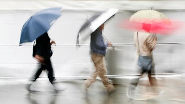 Pedestrians with umbrellas walk through central Sydney in the rain. (File photo: Reuters)