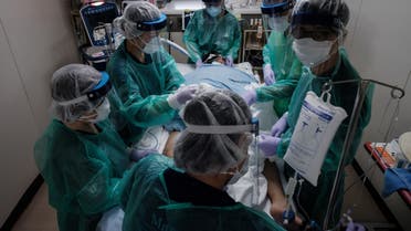 Medical workers in personal protective equipment (PPE) take care of a Covid-19 coronavirus patient in Yokohama on August 8, 2021. (AFP)