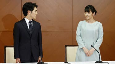 Japan's former princess Mako (R), the elder daughter of Prince Akishino and Princess Kiko, and her husband Kei Komuro (L), at the Grand Arc Hotel in Tokyo on October 26, 2021. (AFP)