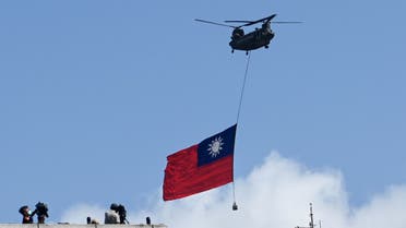 A CH-47 Chinook helicopter carries a Taiwan flag during national day celebrations in Taipei on October 10, 2021. (AFP)