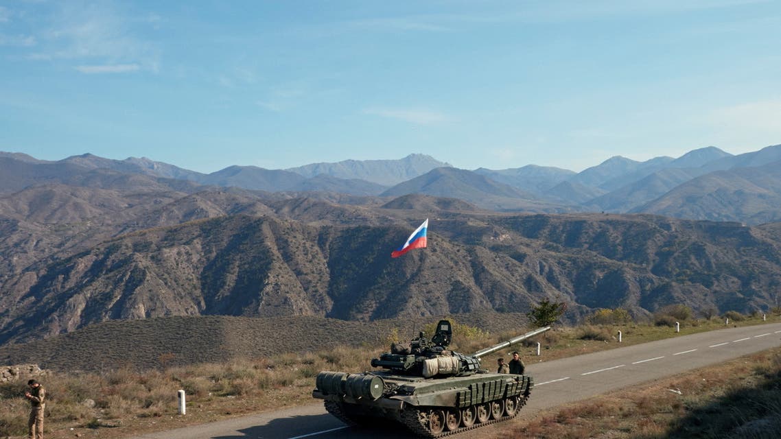 Service members of the Russian peacekeeping troops stand next to a tank near the border with Armenia, Nov.10, 2020. (Reuters)