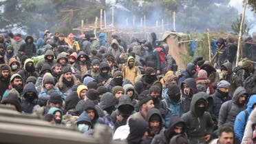Migrants head towards the Polish Kuznica border crossing on the Belarusian-Polish border on November 15, 2021. (AFP)