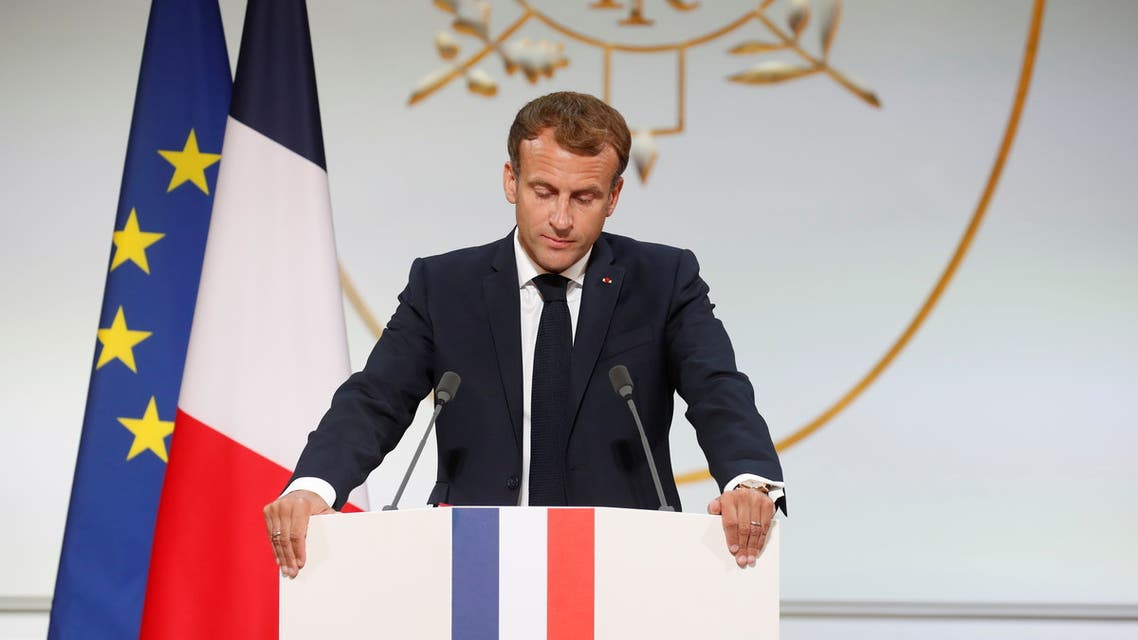 TOPSHOT - French president Emmanuel Macron delivers a speech during a ceremony in memory of the Harkis, Algerians who helped the French Army in the Algerian War of Independence, at the Elysee Palace in Paris, on September 20, 2021. (Photo by GONZALO FUENTES / POOL / AFP)