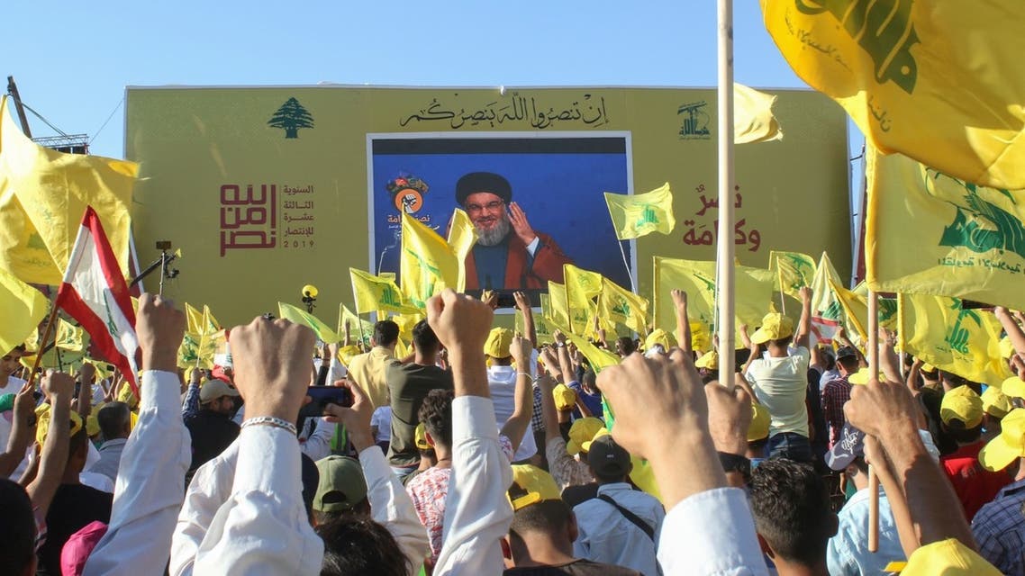 Hezbollah supporters wave the group's flag in the southern Lebanese town of Bint Jbeil, Aug. 16, 2019. (AFP)