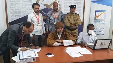 Seif al-Islam, center, the son and one-time heir apparent of late Libyan President Muammar Gadhafi registers his candidacy for the country’s presidential elections next month, in Sabha, Libya, Nov. 14, 2021. (Libyan High National Elections Commission via AP)