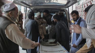 Afghan volunteers help place a wounded man on a stretcher at a hospital after he was injured in a bomb explosion at a mosque during Friday prayers in Jalalabad on November 12, 2021. (AFP)