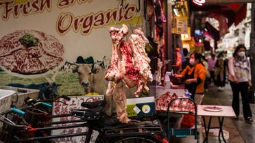 Fresh meat and bones are displayed outside a butcher at a street market in Hong Kong on March 8, 2021. / AFP / Anthony WALLACE