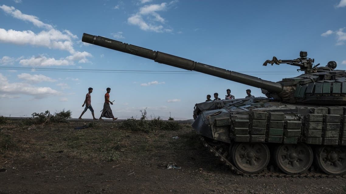 In this file photo taken on December 11, 2020 Youngsters walk next to an abandoned tank belonging to Tigrayan forces south of the town of Mehoni, Ethiopia. (AFP)