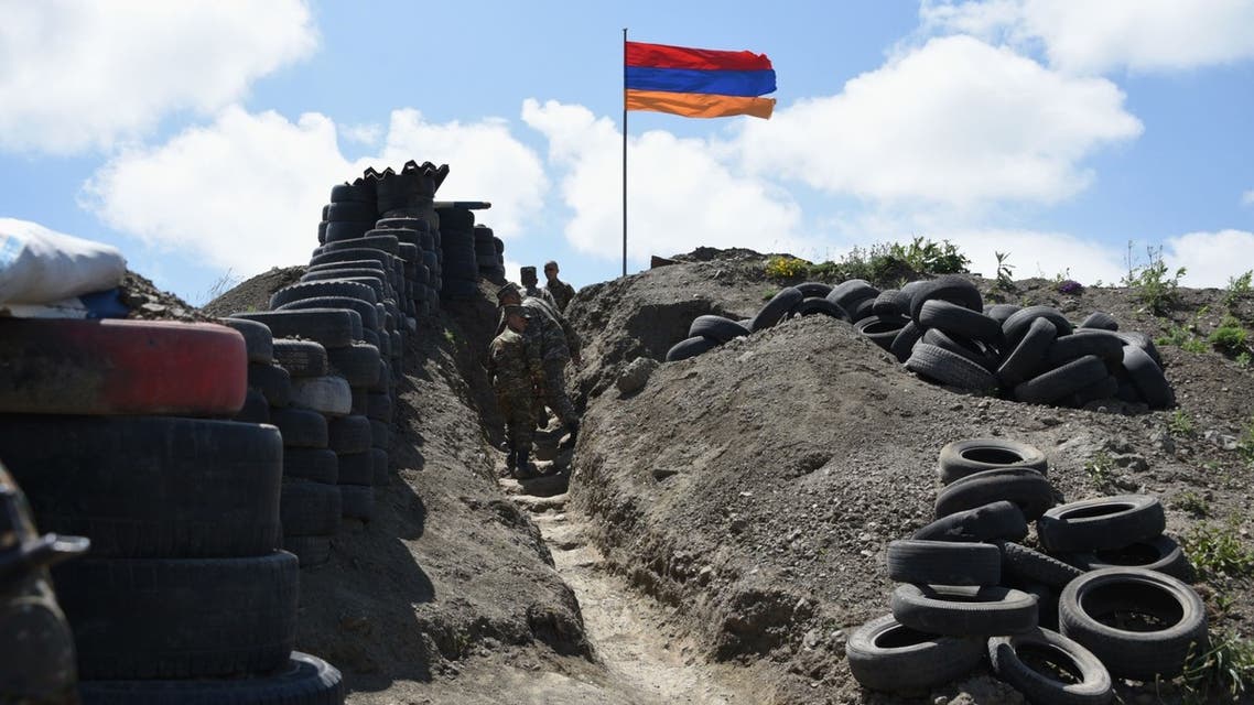 Soldiers walk in a trench at a border check point between Armenia and Azerbaijan near the village of Sotk, Armenia, on June 18, 2021. (AFP)