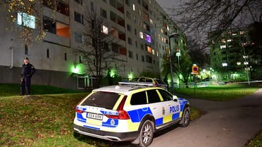 Police cars are seen in front of an apartment block following a suspected crime in Hasselby, northwest Stockholm, Sweden November 15, 2021. (Reuters)