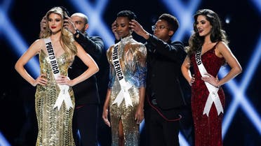 Earmuffs are placed on the heads of first runner up, Madison Anderson of Puerto Rico, and Miss Universe 2019, Zozibini Tunzi of South Africa, as second runner up, Sofia Aragon of Mexico, prepares to compete in the 'Final Word' portion of the Miss Universe pageant at Tyler Perry Studios in Atlanta, Georgia, U.S. December 8, 2019. (Reuters)