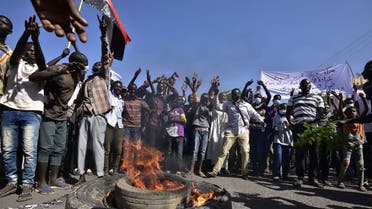 People gesture and chant slogans as they protest against the military coup in Sudan, in Street 60 in the east of capital Khartoum on November 13, 2021. (AFP)