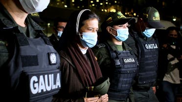 Colombian nun Gloria Cecilia Narvaez is escorted by police after her arrival at El Dorado airport in Bogota, Colombia, on Nov. 16, 2021. (AP)