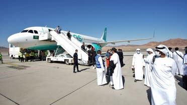 Passengers depart from the first ever international flight to land in Saudi Arabia's AlUla, which set off from Dubai International Airport, on November 19 2021. (Marco Ferrari, Al Arabiya English)