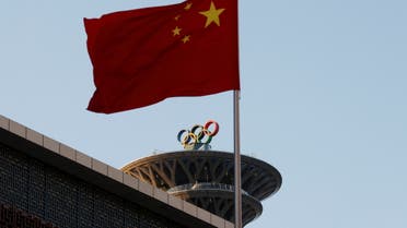 FILE PHOTO: A Chinese flag flutters near the Olympic rings on the Olympic Tower in Beijing, China November 11, 2021. REUTERS/Carlos Garcia Rawlins/File Photo
