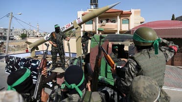 Palestinian Hamas militants ride on a truck as they display a rocket in Rafah, in the southern Gaza Strip May 28, 2021. (Reuters)