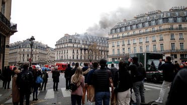 People watch as smoke billows from a building affected by a fire near the Opera Garnier in Paris, France, November 20, 2021. (Reuters)