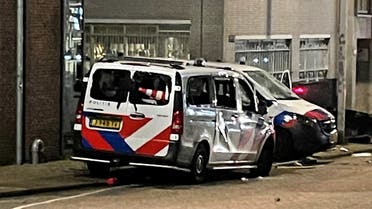 Damaged police vehicles are seen as protests against coronavirus disease (COVID-19) measures turned violent in Rotterdam, Netherlands, on November 19, 2021. (Reuters)