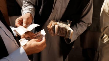 People exchange money in Kabul, Afghanistan October 7, 2021. REUTERS/Jorge Silva