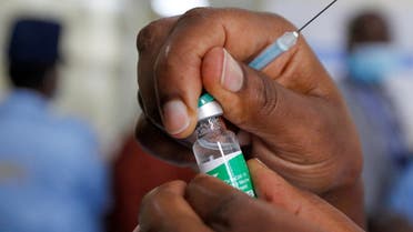 A health worker opens a vial of the AstraZeneca/Oxford vaccine under the COVAX scheme against coronavirus disease (COVID-19) at the Kenyatta National Hospital in Nairobi, Kenya March 5, 2021. (Reuters)