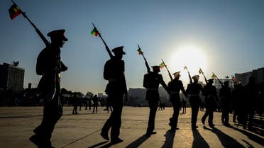 Ethiopian military parade with national flags attached to their rifles in downtown Addis Ababa, Nov. 7, 2021. (AP)