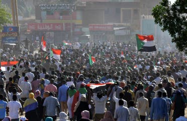 Sudanese protesters lift national flags during a demonstration calling for a return to civilian rule in 40th street in the capital's twin city of Omdurman, on November 21, 2021. (File photo: AFP)
