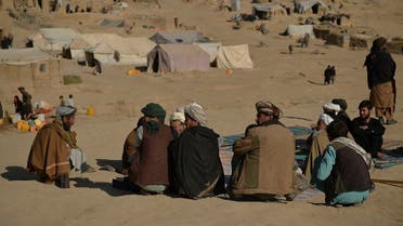 This picture taken on October 17, 2021 shows men sitting at an Internally Displaced People (IDP) camp in Qala-i-Naw, Badghis Province. (Hoshang Hashimi/AFP)
