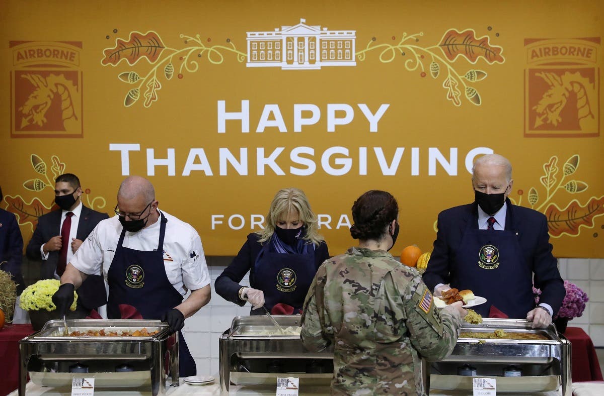  US President Joe Biden and first lady Jill Biden serve food during a Thanksgiving event with US service members and military families at Fort Bragg, North Carolina, US, on November 22, 2021. (Reuters)