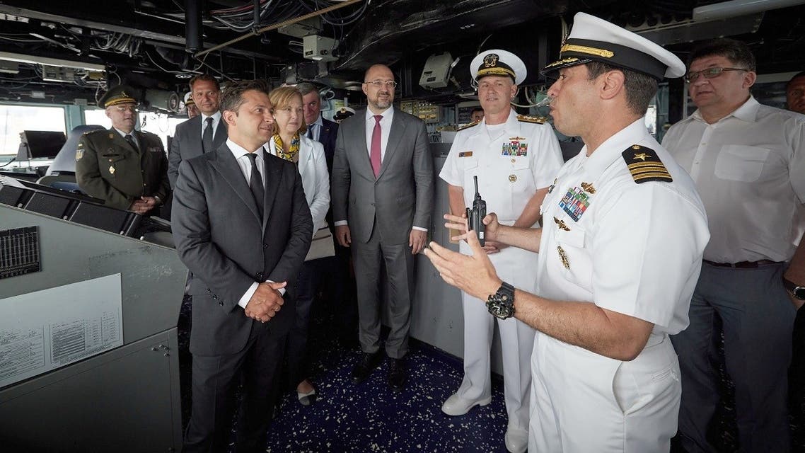A file photo shows Ukraine’s President Volodymyr Zelensky (L) listening to explanations as he visits USS Ross (DDG-71), US Navy guided-missile destroyer, which takes part in international military drills Sea Breeze on July 4, 2021 in Black Sea Ukrainian city of Odessa. (AFP/Ukraine Presidential Press Service/STR)