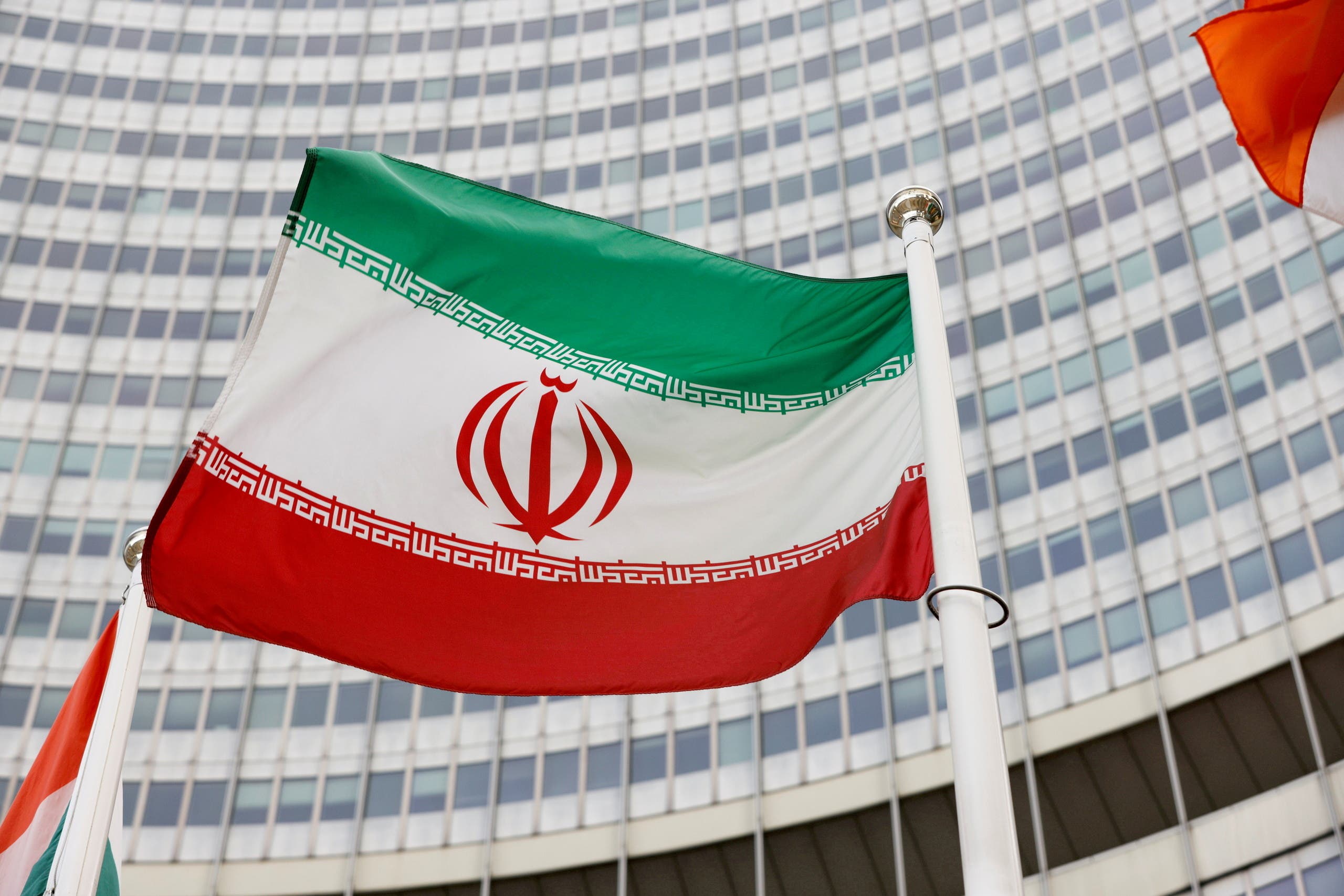The Iranian flag waves in front of the International Atomic Energy Agency (IAEA) headquarters in Vienna, Austria May 23, 2021. (Reuters)