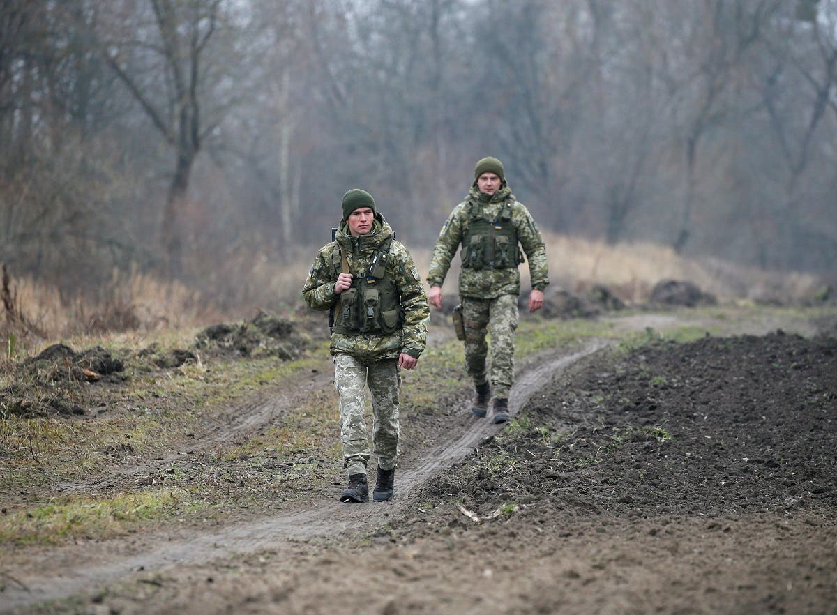 Members of the Ukrainian State Border Guard Service patrol along the Ukraine-Belarus border, near the border with Poland, in Volyn region, Ukraine, on November 16, 2021. (Reuters)