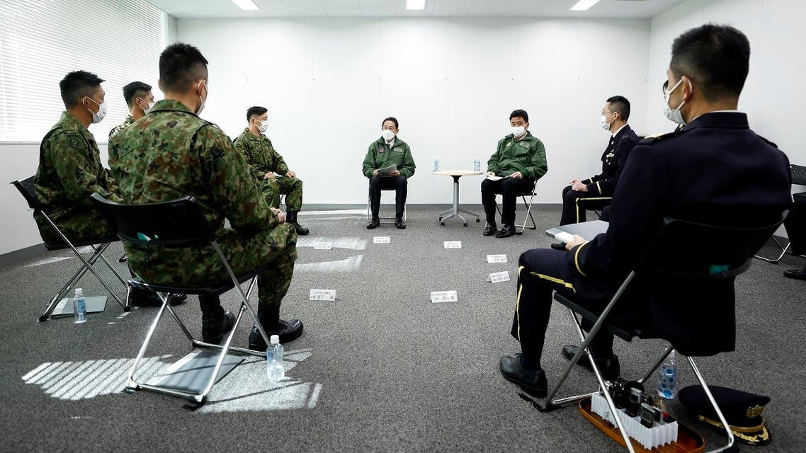 Japan’s Prime Minister Fumio Kishida (center), talks with troops of the Japan Self-Defense Forces during a review at Japan Ground Self-Defense Force Camp Asaka in Tokyo, Japan, on Nov. 27, 2021. (AP)
