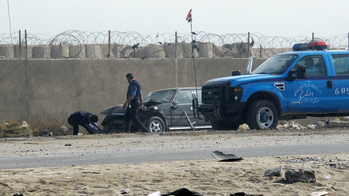 People prepare to tow away a car damaged by a suicide car bomb explosion in the town of Taji, about 12 miles (20 kilometers) north of Baghdad, Iraq, Monday, Nov. 28, 2011. (AP)
