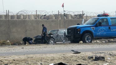 People prepare to tow away a car damaged by a suicide car bomb explosion in the town of Taji, about 12 miles (20 kilometers) north of Baghdad, Iraq, Monday, Nov. 28, 2011. (AP)