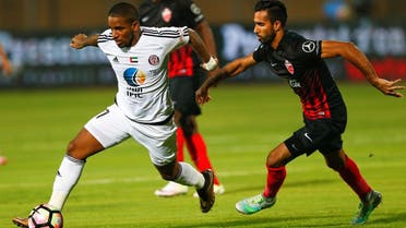 Waleed Abas of Al Ahli and Jefferson Farfan of Al Jazira in action during the Arabian Gulf Super Cup in Cairo, Egypt. (Reuters)