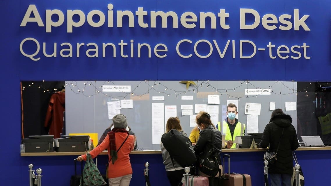 People wait in front of an “Appointment Desk” for quarantine and coronavirus disease (COVID-19) test appointments inside Schiphol Airport, in Amsterdam, Netherlands, November 27, 2021. (Reuters/Eva Plevier)