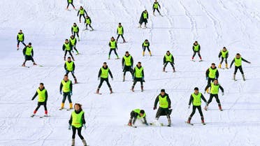 Participants ski during a Beijing 2022 Winter Olympic Games themed event at a ski resort in Zhangye, Gansu province, China, on December 23, 2019.  (Reuters)
