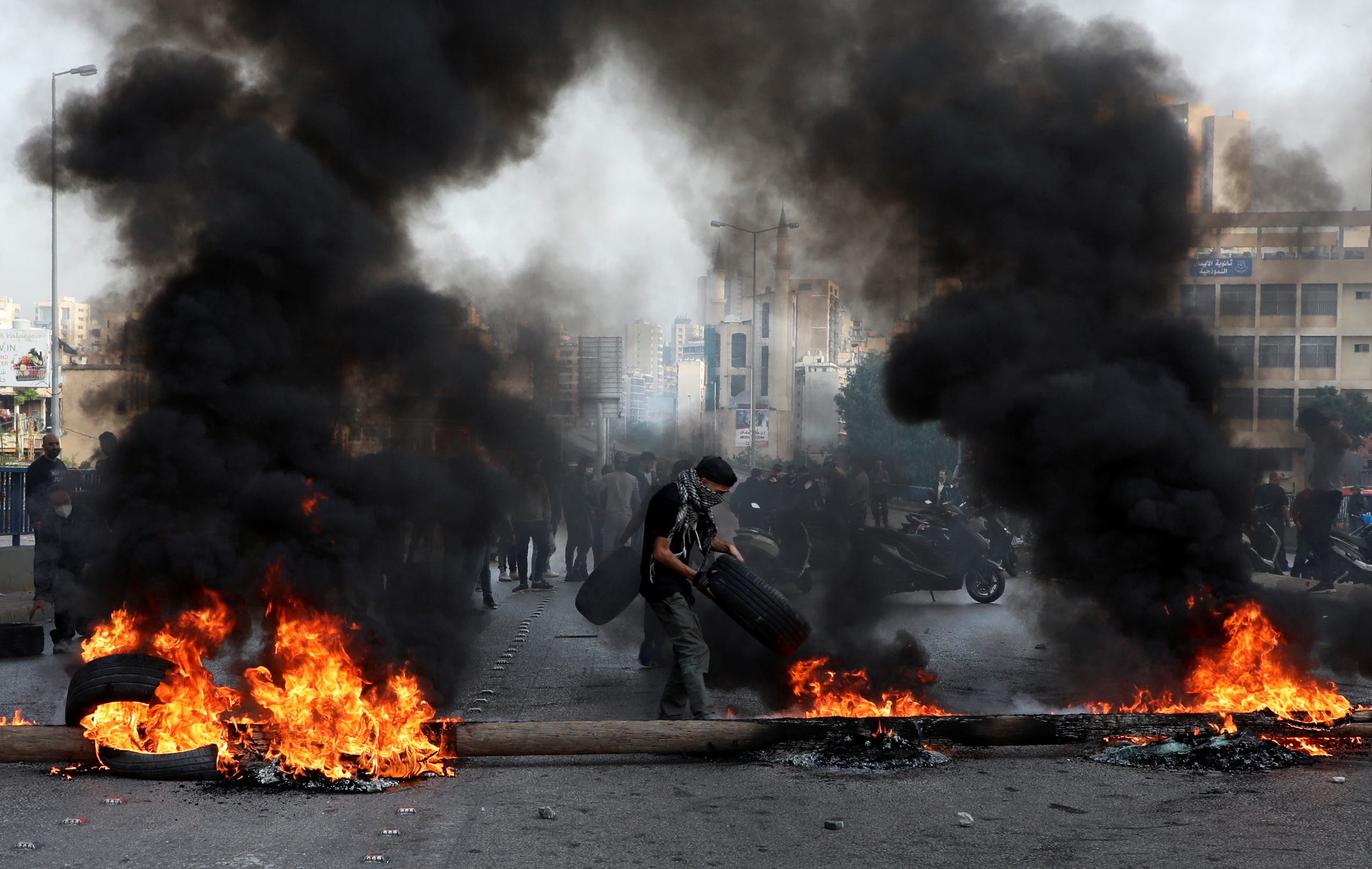 Demonstrators block a road with burning tires during a protest on the back of the continuing deterioration of living conditions, in Beirut, Nov. 29, 2021. (Reuters)