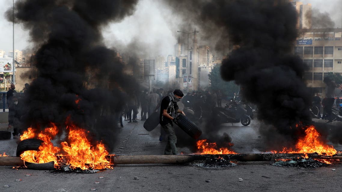 Demonstrators block a road with burning tires during a protest on the back of the continuing deterioration of living conditions, in Beirut, Lebanon November 29, 2021. (Reuters)