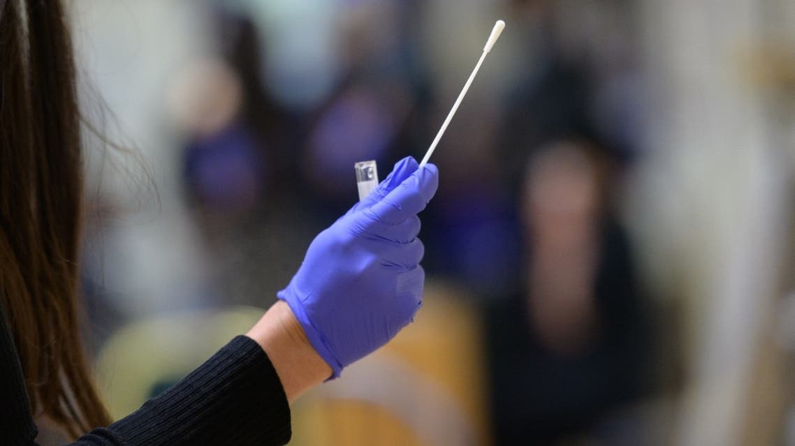 A nurse holds up a coronavirus nasal swap on April 27, 2021 in New York City. (AFP)