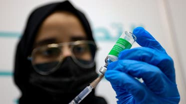 A health worker prepares an injection of the Oxford–AstraZeneca vaccine (Covishield) against the coronavirus at a vaccination centre, set up at the Dubai International Financial Center in the Gulf emirate of Dubai, on February 3, 2021. (AFP)
