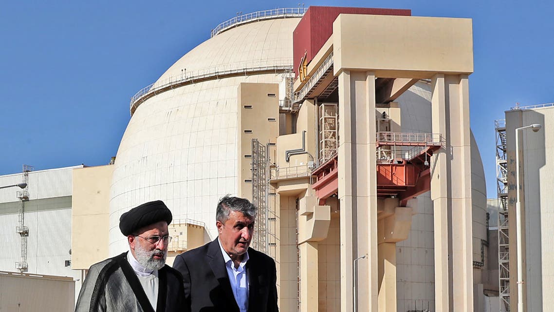 A handout picture provided by the Iranian presidency on October 8, 2021 shows Iran's president Ebrahim Raisi (R) accompanied by chief of the Atomic Energy Organisation of Iran Mohammad Eslami, visiting the Bushehr Nuclear Power Plant, southeast of the city of the same name. (AFP)